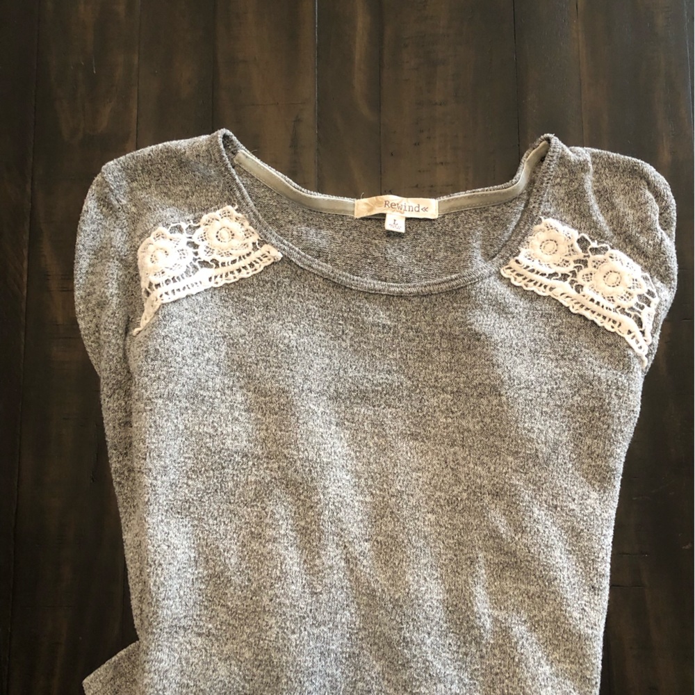 Cute top with Sweater front and sleeves. Sheer blouse back and accent lace.